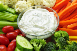 A homemade creamy salad dressing with veggies to dip.